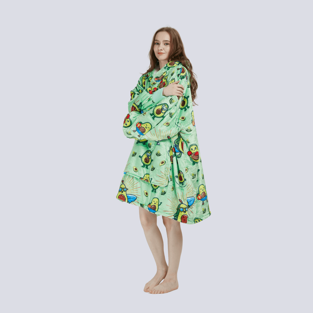Adult model wearing the Avocado Wrap hoodie blanket with arms crossed, highlighting the plush fleece texture and comfort.