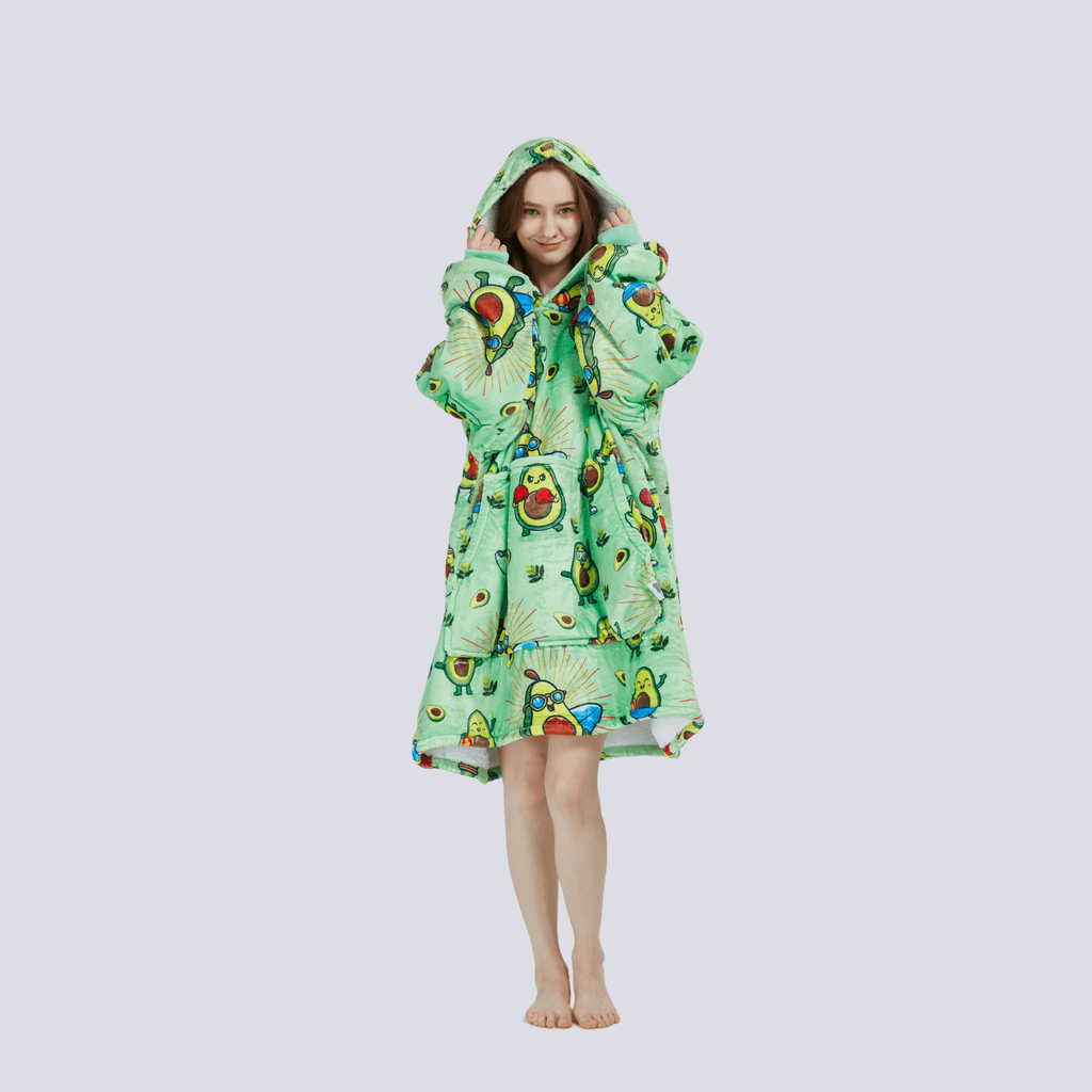 Adult wearing the Avocado Wrap hoodie blanket with hood up, showcasing sherpa fleece lining and cozy design.