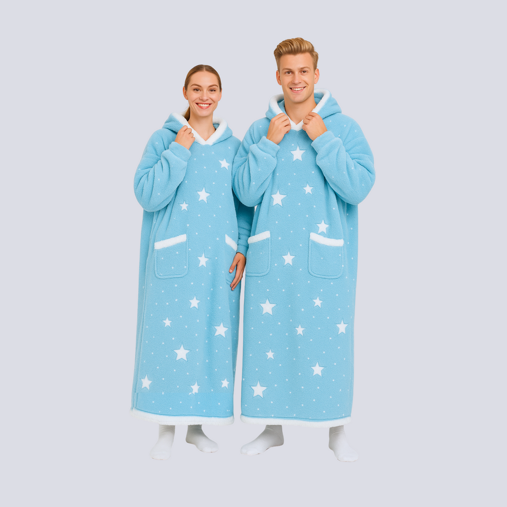 Oversized baby blue hoodie blanket with star pattern worn by male and female models standing together