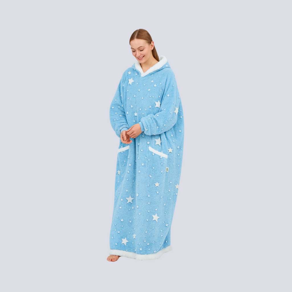 Female model in baby blue hoodie blanket standing angled, showcasing cozy fit and star design