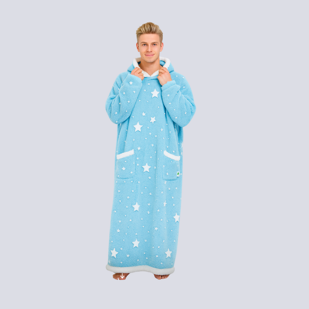 Male model wearing oversized baby blue hoodie blanket with white sherpa hem and star print, front view