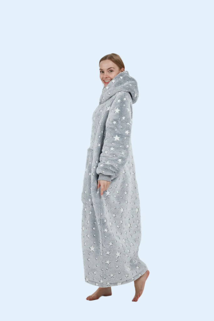 Playful walking pose in plush oversized star hoodie blanket, showing comfort and flow.