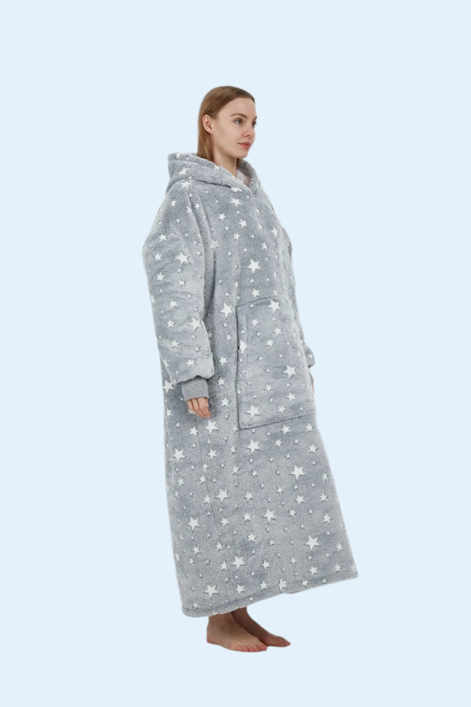 Side profile showing the volume and cozy drape of the grey star hoodie blanket.