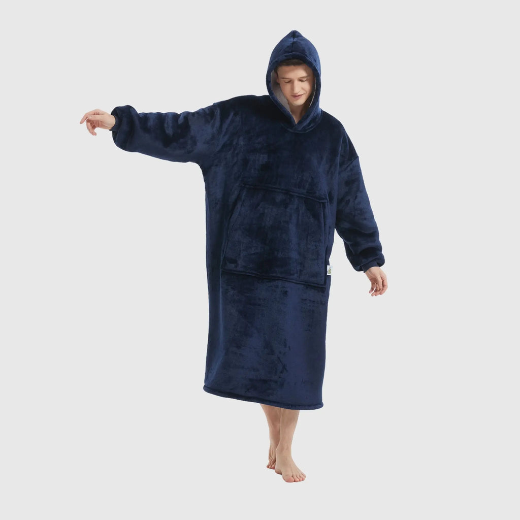 Front-facing view of navy wearable blanket with model showing loose fit and pocket