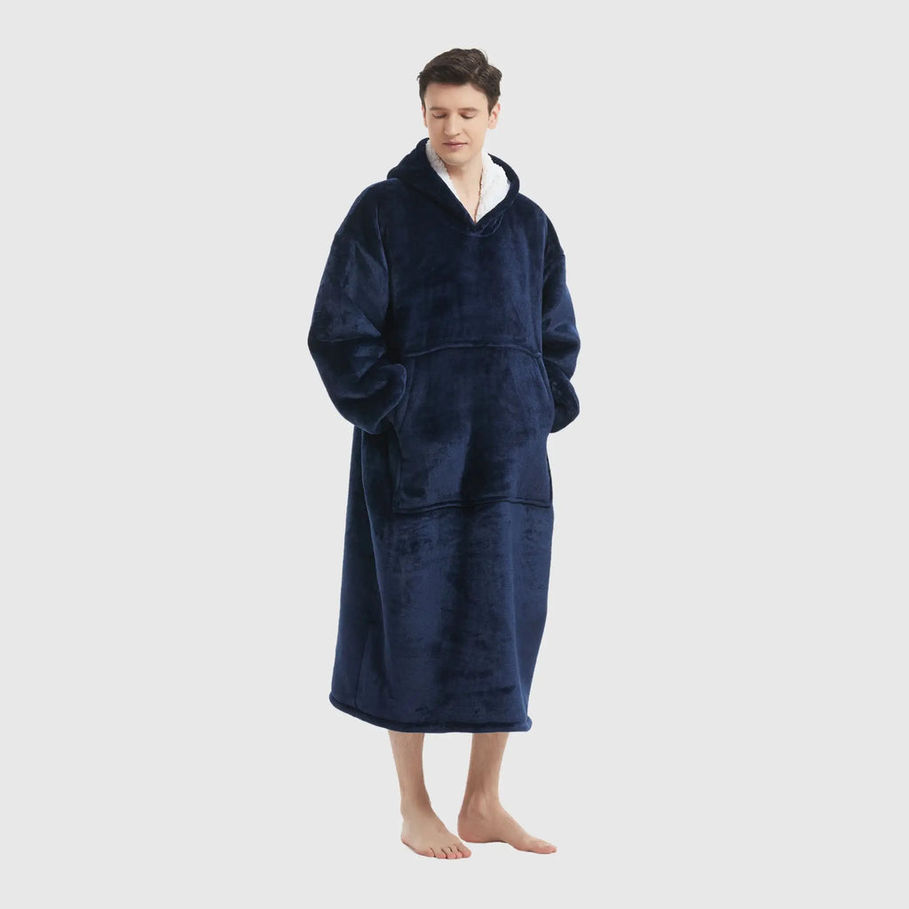 Navy wearable blanket hoodie styled with model's hands in front kangaroo pocket