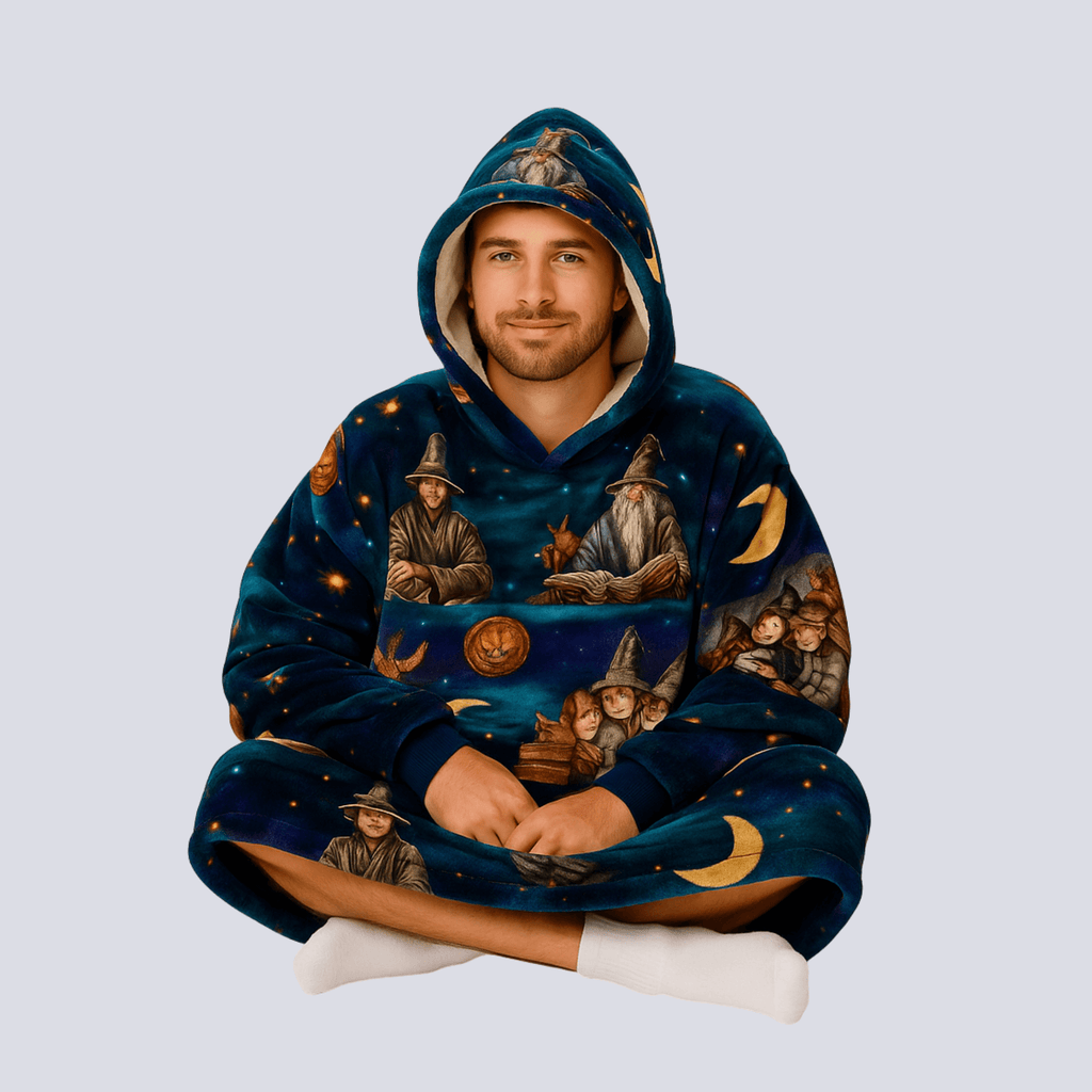 Adult model sitting cross-legged in Wise Wizard Warrior hoodie blanket, demonstrating oversized cozy fit.